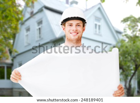 renovation, building, people and home concept - male builder or architect in helmet holding blueprint over living house background