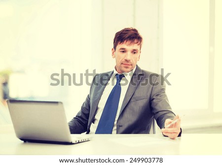 technology, business and office concept - puzzled businessman working with laptop computer and documents