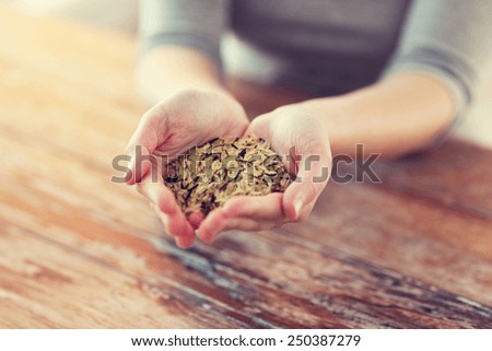 cooking and home concept - close up of female hands with pile of mixture of white and wild black rice