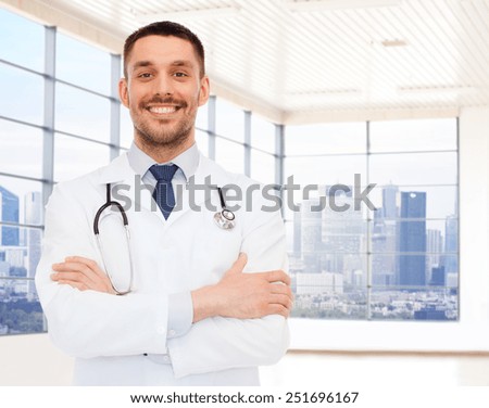healthcare, profession, people and medicine concept - smiling male doctor with stethoscope in white coat over clinic room background