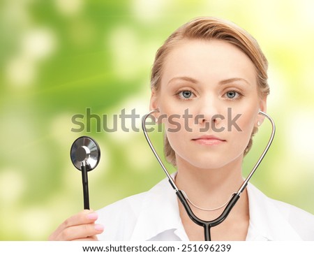 people, medicine, equipment and profession concept - young female doctor with stethoscope over green background