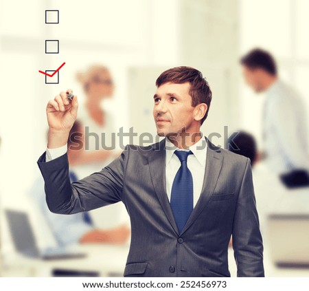 business and office concept - attractive buisnessman or teacher with marker