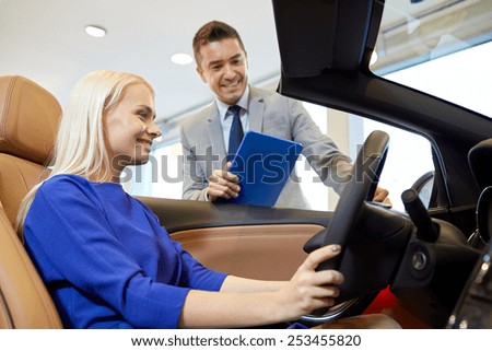 auto business, car sale, technology and people concept - happy woman and car dealer with tablet pc computer in auto show or salon
