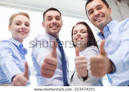 business, teamwork, success, people and gesture concept - smiling business team showing thumbs up in office