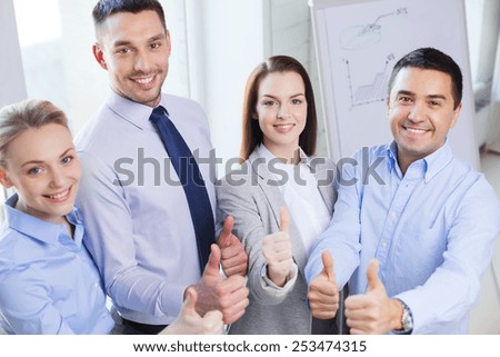 business, teamwork, success, people and gesture concept - smiling business team showing thumbs up in office