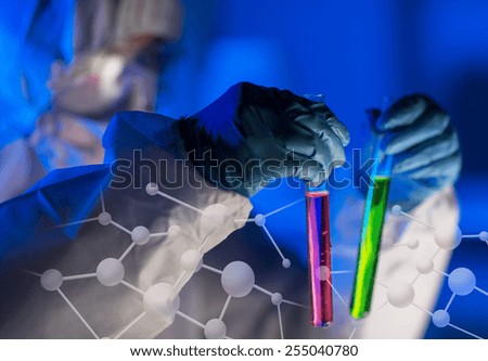 science, chemistry, biology, medicine and people concept - close up of young female scientist holding tubes with chemicals making test or research in laboratory