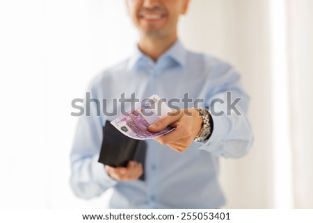 people, business, finances and money concept - close up of businessman hands holding open wallet with euro cash