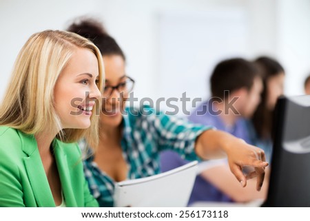 education, technology and internet - students with computer studying at school