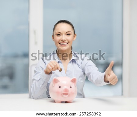 banking and finances concept - lovely woman with piggy bank and cash money showing thumbs up
