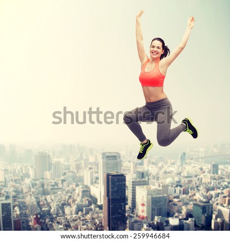 fitness and diet concept - beautiful sporty teenage girl jumping in sportswear