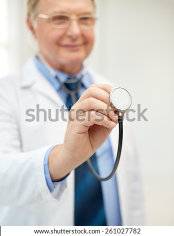 healthcare, profession, people and medicine concept - close up of happy doctor in white coat with stethoscope at medical office