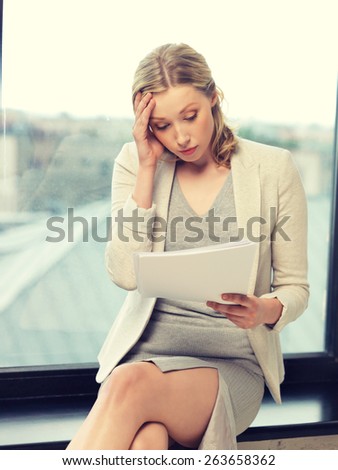 indoor picture of worried woman with documents