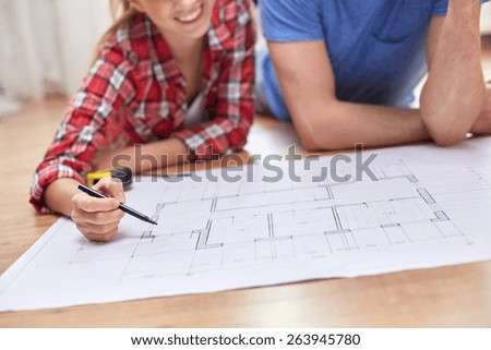 repair, building, renovation and people concept - close up of happy couple looking at blueprint at home