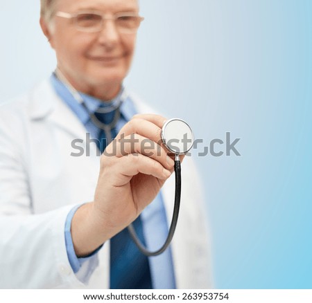 healthcare, profession, people and medicine concept - close up of happy doctor in white coat with stethoscope over blue background