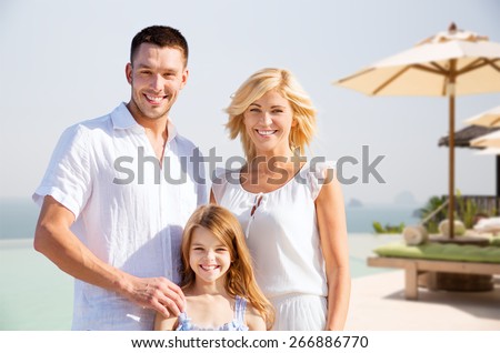 summer holidays, travel, tourism and people concept - happy family on vacation over resort beach background