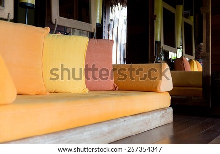comfort, leisure, design and interior decoration concept - couch with pillows at hotel room or home