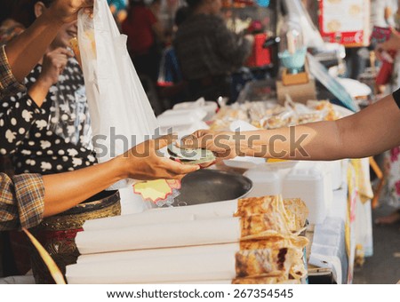 sale, retale, shopping and food concept - close up of hands giving money at street market