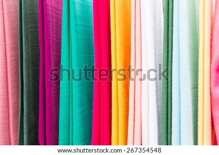 shopping, industry, sale and clothing concept - colorful textile at asian street market
