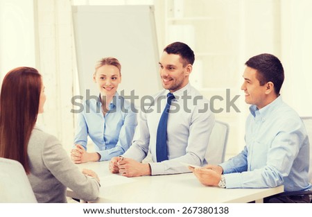 business, interview, employment and office concept - business team with tablet pc computer interviewing worker in office