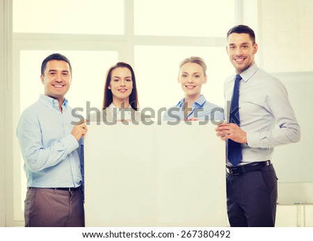 business and office concept - happy business team in office with white blank board
