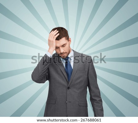 business, fail and crisis concept - young businessman having headache over blue burst rays background