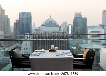 travel, vacation, tourism and business concept - roof top restaurant lounge at hotel in bangkok city