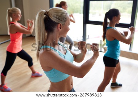 fitness, sport, training, people and lifestyle concept - group of women working out martial arts in gym