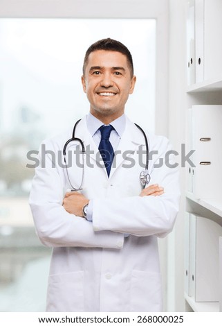 healthcare, profession, people and medicine concept - smiling male doctor in white coat at medical office