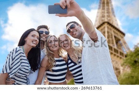 summer, france, tourism, technology and people concept - group of smiling friends taking selfie with smartphone over eiffel tower in paris background