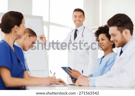 hospital, profession, medical education, people and medicine concept - group of happy doctors meeting on presentation at hospital