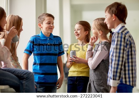 education, elementary school, drinks, children and people concept - group of school kids with soda cans talking in corridor