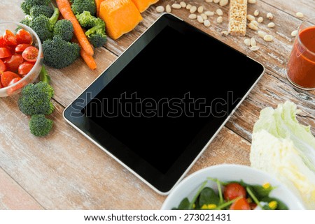 healthy eating, dieting, slimming and weigh loss concept - close up of black blank tablet pc screen and vegetables
