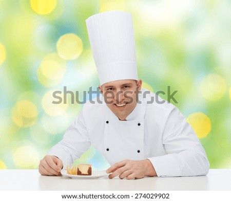 cooking, profession, haute cuisine, food and people concept - happy male chef cook decorating dessert over green lights background