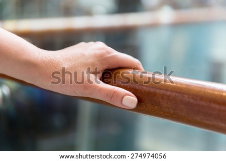 support, help and people concept - close up of woman hand holding to railing
