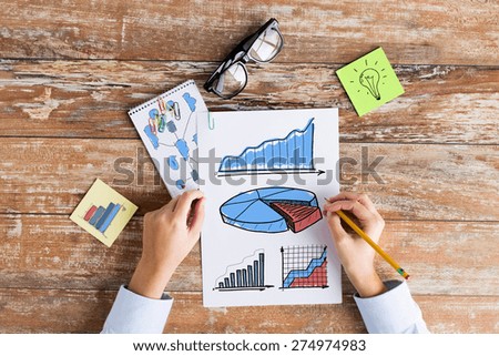 business, education, planning, strategy and people concept - close up of hands drawing charts and chart on paper sheets at table