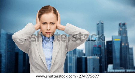 business, emotions, stress, pressure and people concept - stressed businesswoman with covered ears over city background