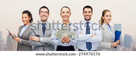 business, success and finances concept - group of smiling business people with dollar cash money over city background