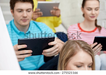 education, technology, people and internet concept - close up of students with tablet pc computers at school