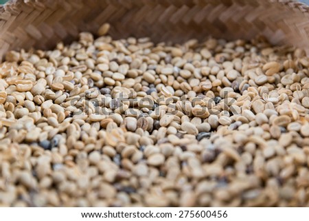 sale, harvest, agriculture and food concept - close up of unroasted coffee beans in basket