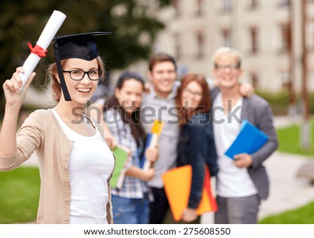 education, campus, friendship, graduation and people concept - group of happy teenage students with diploma school folders