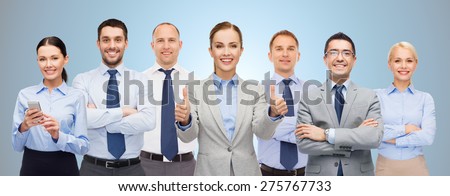 business, people, corporate, teamwork and office concept - group of happy businesspeople showing thumbs up over blue background