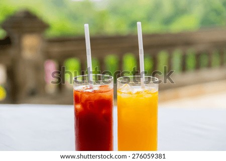 fruit and vegetable drinks concept - glasses of fresh orange and tomato juice at restaurant