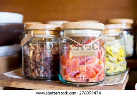 food, storage and eating concept - close up of jars with dried fruits at grocery