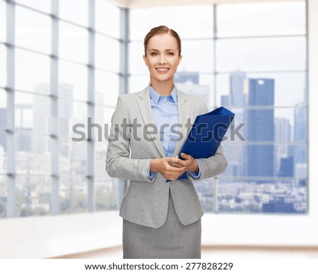 business, people, real estate and sale concept - smiling young businesswoman holding folder over office or empty city apartment background