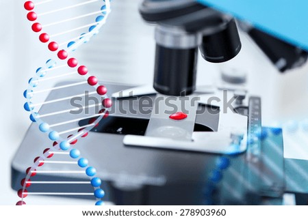 science, chemistry, biology, medicine and research concept - close up of microscope with blood test sample in clinical laboratory