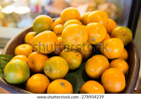 cooking, kitchen, vegetarian food, fruits and citrus concept - basket of of fresh ripe oranges fruits at kitchen