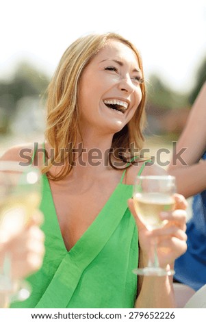 summer holidays, vacation and celebration concept - laughing woman with wine glass