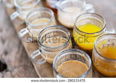 drinks and sale concept - glasses of juice at market stall or restaurant