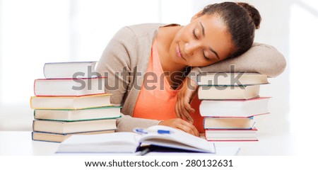 education and business concept - tired student with pile of books and notes studying indoors