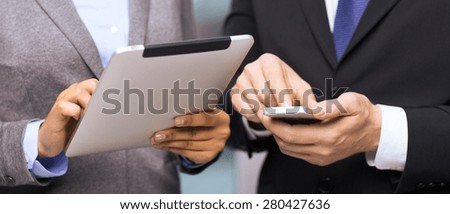 business, technology, internet and office concept - businessman and businesswoman with smartphone and tablet pc computer in office